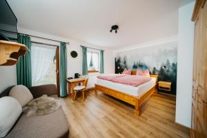 费尔德伯格Schwarzwald-Hotel Kraeutle的一间卧室配有一张床和一张沙发