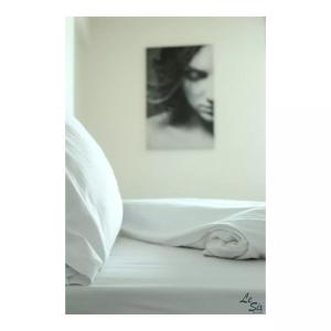 拜特龙Le Six Hotel And Resort的一张黑白的女人在床下的照片