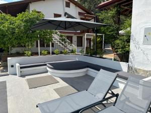 阿奇亚卡Tomsan Villas Akyaka的庭院配有两把椅子和一把遮阳伞