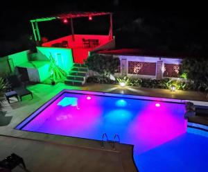 贝贝里比Pousada Villa Flamboyant的游泳池在晚上点亮