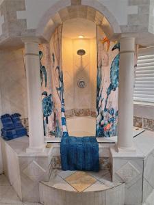 圣徒皮特海滩Blind Pass Resort Motel的建筑中设有淋浴的房间,有柱子