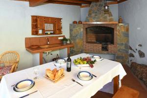 蒂哈拉费Ferienhaus für 6 Personen ca 105 qm in La Punta, La Palma Westküste von La Palma的一张桌子,上面有白色的桌布和一个壁炉