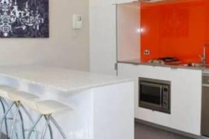 悉尼One Bedroom Unit at Sydney Best Location的厨房配有白色橱柜和微波炉