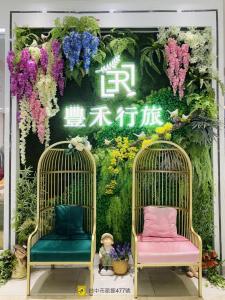 台中市台中丰禾行旅的两把椅子,在鲜花墙前