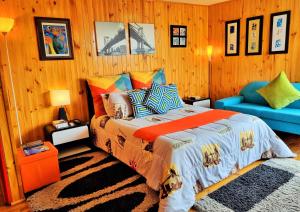 瓜塔维塔El Remanso Guatavita的一间卧室配有一张床和一张蓝色的沙发
