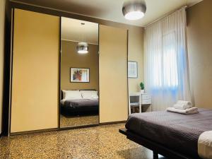 博洛尼亚Bononia Host - Beverara的卧室内的大镜子,配有床
