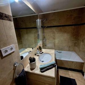 洛斯阿尔卡萨雷斯Casa Allegra的一间带水槽和浴缸的浴室