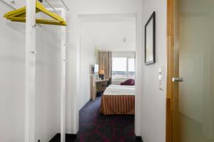 哈马尔Frichs Hotel Hamar的走廊,带一张床的酒店客房