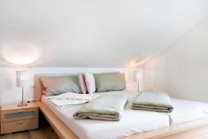 凯萨斯图尔地区萨斯巴赫Ferienwohnung In Der Weinig的一张白色的床,上面有两个枕头