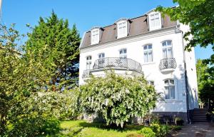 巴贝Villa im Ostseebad Baabe的一座白色的建筑,上面设有一个阳台