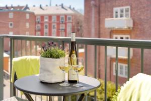 奥斯陆美卓斯托公寓的阳台上的桌子和两杯葡萄酒