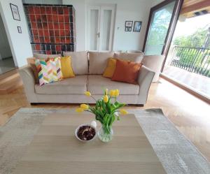 蒂豪尼Dorka Villa的客厅配有沙发和鲜花花瓶