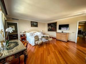 博尔迪盖拉戴尔玛尔度假及SPA大酒店的一间卧室设有一张大床,铺有木地板