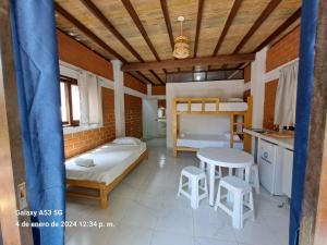 曼克拉Punta Pacífico Bungalows Máncora的卧室配有一张床和一张桌子及椅子