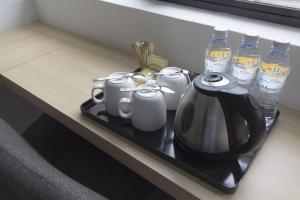 劳勿HOTEL RAUB since 1968的一个带茶壶和瓶装水的托盘