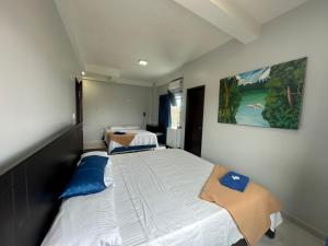 塔巴廷加Hotel Cristo rey的配有两张床铺的小卧室,墙上挂着一幅画