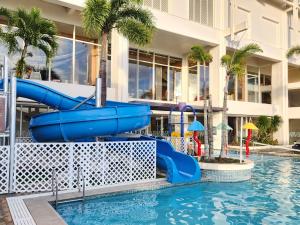 塔穆宁关岛乐天酒店的度假村游泳池的水滑梯