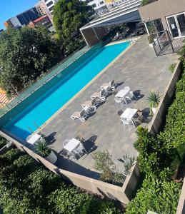 纽卡斯尔AQUA 306 POOLSIDE Luxury Apartment , Honeysuckle, NEWCASTLE FREE Parking的享有带桌椅的游泳池的顶部景致