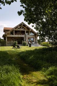 ZottegemBeautiful log home with stunning views的草坪上带门廊的大型木屋