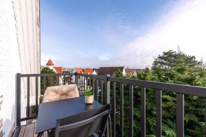 克诺克－海斯特Lovely new apartment in Knokke-Heist nearby the beach的阳台配有桌椅,享有美景。