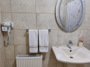 马达巴CMK Housing的浴室配有盥洗盆、镜子和毛巾