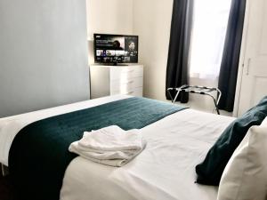 滨海绍森德Coastal Apartment的一间卧室配有一张白色的床,其中配有电视