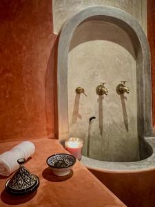 马拉喀什Riad Hotel Sherazade的一间带镜子和水槽的浴室