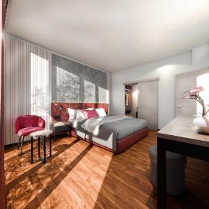 加尔达湖滨Garda Suite Hotel - TonelliHotels的一间卧室配有一张床、一张桌子和一把椅子