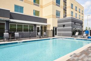 奥兰多Fairfield by Marriott Inn & Suites Orlando at Millenia的大楼前的大型游泳池