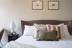 福伊The King的一间卧室配有带白色床单和枕头的床。
