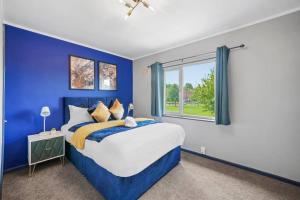 布里斯托Spacious Luxury Garden House Free Parking的蓝色的卧室设有床和窗户