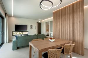 MódhionDeux Olives Luxurious & Quality Villa的一间带桌子和沙发的用餐室