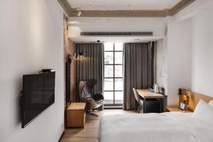 台中市新蓝天旅栈的配有一张床和一张书桌的酒店客房