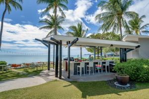 查汶苏梅岛遨舍查汶度假酒店的棕榈树海滩上的餐厅