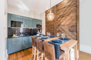 波尔图GuestReady - Modern luxe getaway in Vitória的厨房配有带蓝色橱柜的木桌