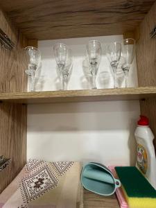 久姆里Mtour Apartment的木架上装有玻璃杯和剪刀