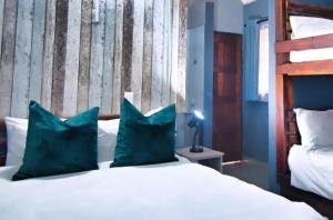 内尔斯普雷特Ndalo Lodge Mbombela的一间卧室配有一张带两个蓝色枕头的床