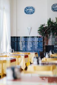 阿姆斯特丹阿姆斯特丹维赫曼酒店的用餐室配有桌子和黄色椅子