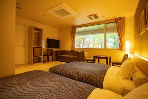 旭川Morinoyu Hotel Hanakagura的一间带两张床的卧室和一间客厅