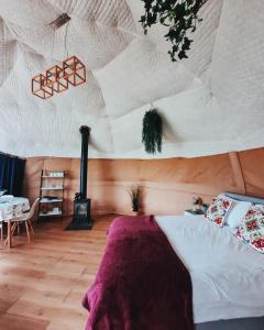 赫里福德Greenacres Glamping的一间卧室设有一张床和一个壁炉。