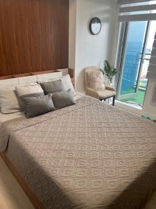 圣费尔南多The Aces Crib at Azure North Pampanga的一间卧室设有一张大床和大窗户