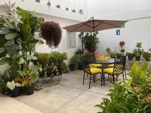 科利马El Rincon de Los Angeles的天井配有桌椅和盆栽植物