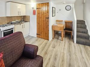 StaintondaleCart Cottage - 28343的带沙发和桌子的客厅以及厨房。