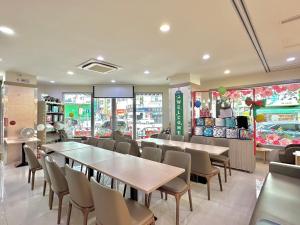 台中市美之旅商务饭店的一间带桌椅的餐厅和一间商店