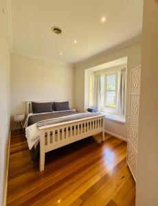 墨尔本Townhouse Near The World’s Coolest High st in 2024的一间卧室设有一张大床和一个窗户。
