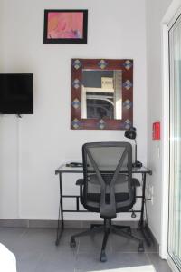 IdronStudio 20m² au calme à Idron (5min de Pau)的一张桌子和椅子,位于带镜子的房间里