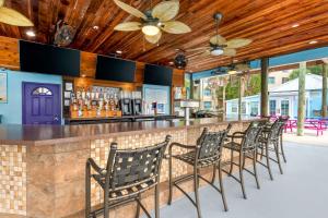 奥兰多Hilton Vacation Club Aqua Sol Orlando West的酒吧,餐厅里摆放着一排椅子