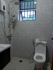 基加利Kigali Grand Villa的带淋浴、卫生间和盥洗盆的浴室
