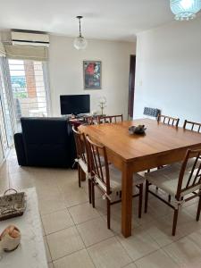 玛利亚镇Departamento céntrico villa maría的客厅配有木桌和椅子