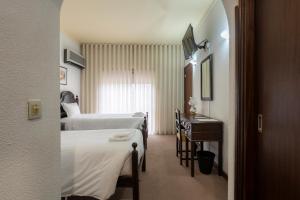 塞洛里库达贝拉米拉塞拉酒店的酒店客房设有两张床和一张桌子。